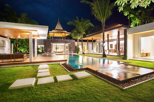 Interior and exterior design of pool villa which features living area, greenery garden, pavilion